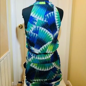 Sleeveless Faux wrap top with peplum effect. Gorgeous jewel tones